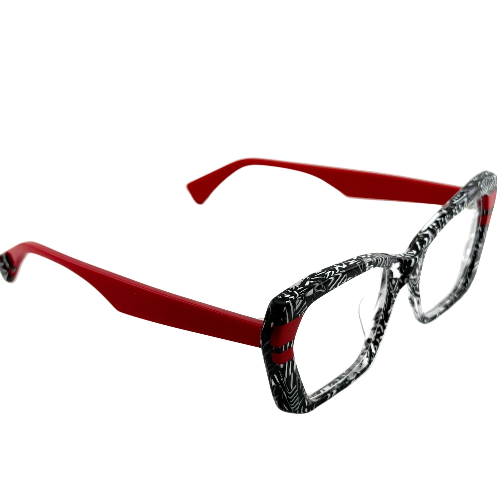 Eyeglasses with red frame and black and white patterned lenses on a white background